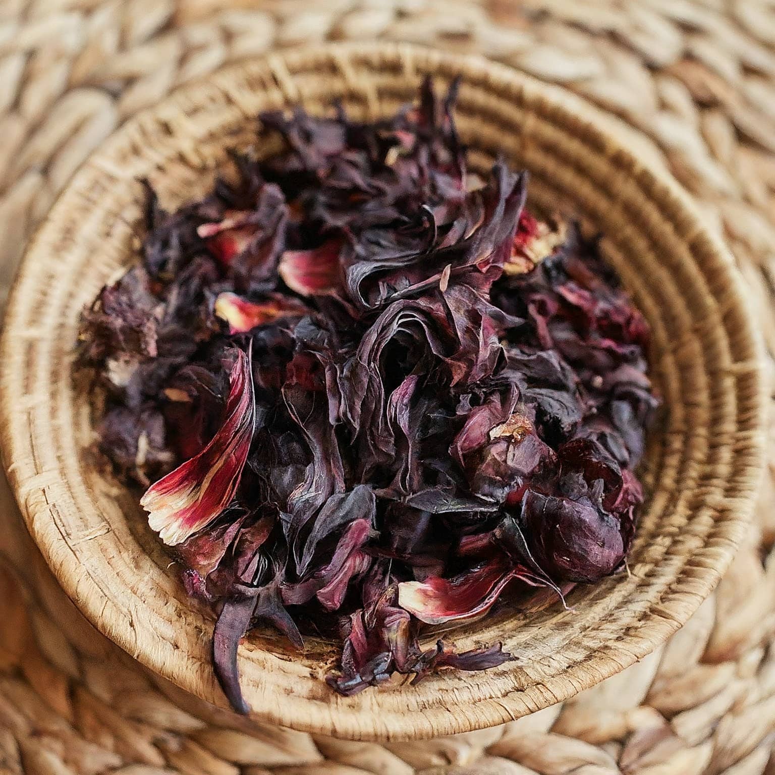 Dried hibiscus flowers in a woven basket